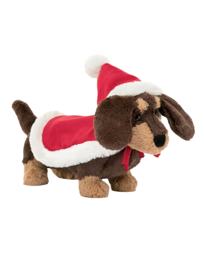 Jellycat Winter Warmer Otto Sausage  Winter Warmer Otto Sausage Dog is setting new trends for holiday fashion! This floppy-eared pup wears a bold red hat-and-cape combo, with a fleecy trim and bobble pompom, which fastens on with a red ribbon tie. It goes so well with Otto's cocoa fur, splashed with caramel patches!