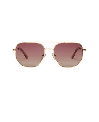 Gold-framed sunglasses with pink gradient lenses on a white background