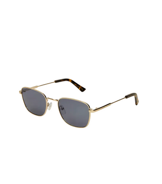 Gold-framed sunglasses with dark lenses on a white background