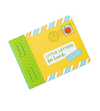 A children's notebook or journal titled 'Little Letters for Lunch' shown closed on a bright blue background. The cover is primarily yellow with a green patterned spine, striped border accents in white, orange, and blue, and a small red apple postage stamp graphic.