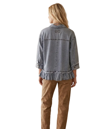 a woman facing backward wearing a Tencel Ruffle Hem Shirt