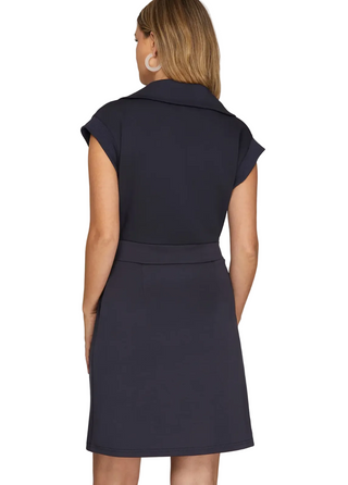 a woman wearing a  mini Navy Scuba Dress