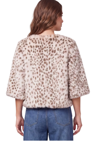 a woman wearing a  cream Fawn Faux Fur Jacket