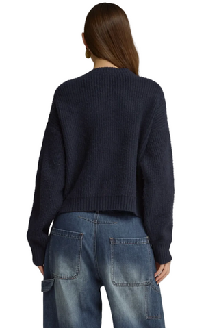 a woman wearing a  Navy with Plaid Sweater