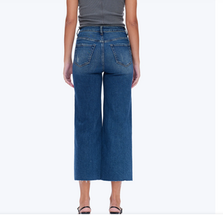 a woman wearing High Rise Cropped Distressed Wide Leg Jeans
