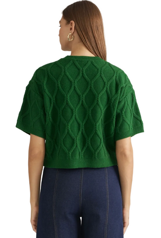 a woman wearing a Pine Short Sleeve Cable Knit Sweater