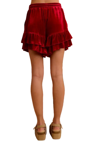 a woman wearing Velvet Ruffled Shorts - Crimson