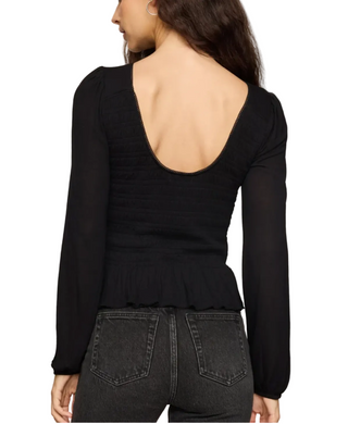 a woman wearing a Z Supply Black Carey Smocked Peplum Top