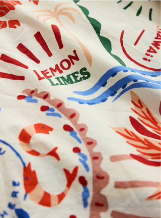 Textured fabric with colorful designs and text on a white background