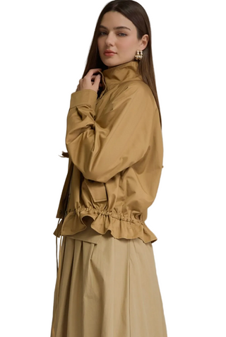 Side view of golden-tan jacket with stand collar, zip front, long sleeves, and drawstring hem