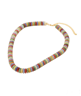 Colorful beaded necklace on a beige background