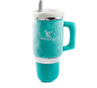A plush novelty mug toy in a bright teal color with a white handle, white rim, and a silver metallic band. The word 'SNUGGLY' is printed on the front in white, accompanied by a small bird logo.
