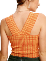 Spicy Citrus Plaid Sweater Brami  Get fun and chic in our Plaid Sweater Knit Brami Top, drenched in vibrant shades of orange. This trendy must-have seamlessly combines comfort and style, making it perfect for fall fashion. Rock it solo or layer with flair to turn heads all season long.   Material:  77% Viscose 20% Nylon 3% Spandex back