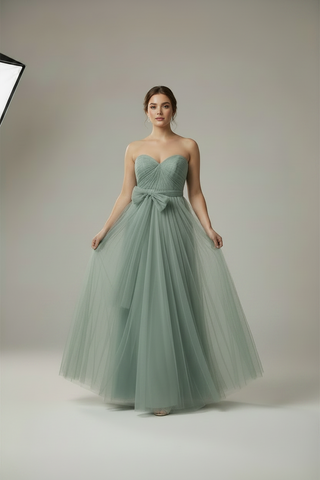 woman is a long sage dress posing for a photo
