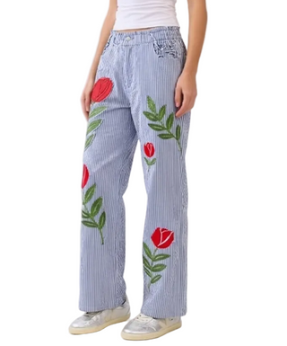 blue and white striped ants with flowers embroidered on it