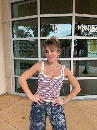 Person wearing a striped tank top and patterned pants standing in front of a glass door. Striped Simply Soft Cami
