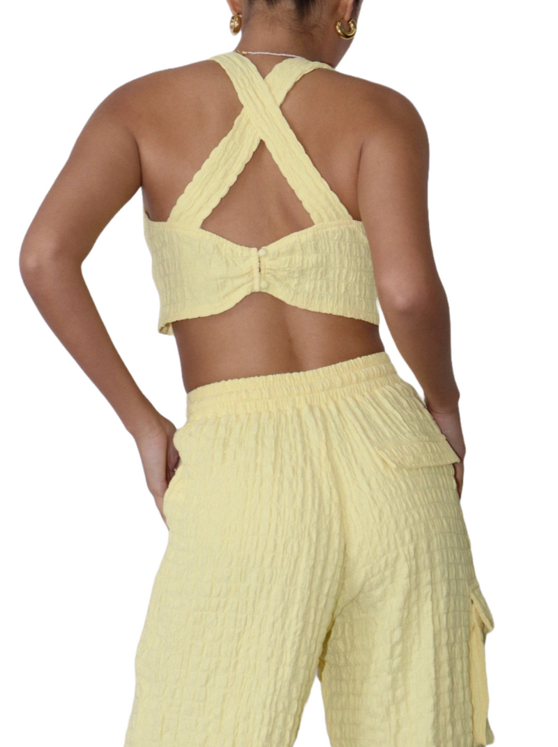 Sunshine Adventure Crop Top  Amidst an autumn day, don this crinkle knit crop top, setting the fashion stage. With criss-cross straps adding flair, you're a trendsetter on display, A vibrant burst of sunshine in the midst of the fall's elegant array.   Material: 100% Polyester back