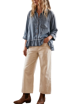 a woman wearing a denim Tencel Ruffle Hem Shirt
