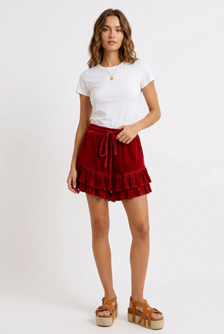 a woman wearing Velvet Ruffled Shorts - Crimson