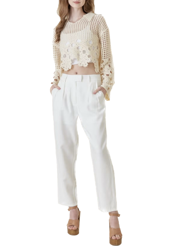 This beige crochet long sleeve top is a nostalgic fashion piece that transports you back to cherished moments spent at your grandma's house. Its design exudes a sense of warmth and comfort, reminiscent of the cozy atmosphere around her dining room table adorned with delicate doilies.