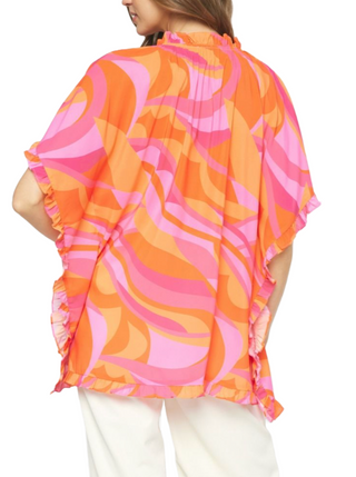 Warm Smile Top  Printed v-neck ruffle sleeve poncho style top featuring self tie at front neck. Unlined. Woven. Non-sheer. Lightweight.  Material: 100% Polyester back
