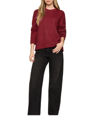 a woman wearing a Z Supply Cloud Spun Shaped Crew Sweater - Red Dahlia