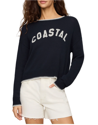 A woman wearing  a  navy Z Supply Coastal Sweater