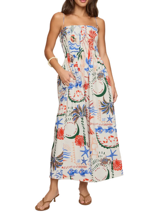 Woman wearing a colorful floral dress on a plain background