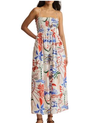 Woman wearing a colorful floral dress on a plain background