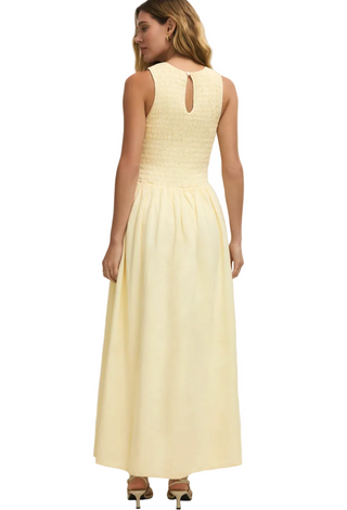 Woman wearing a light yellow dress on a white background