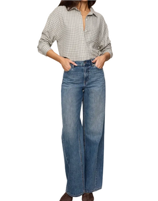a woman wearing denim jeans with a green  Z Supply River Plaid Button Up