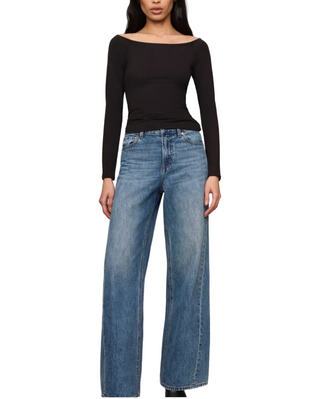 a woman wearing a black Z Supply Sabrina Top - Black. with blue denim jeans 