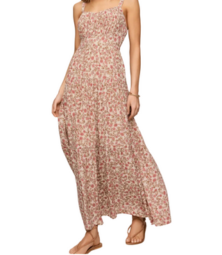 Woman wearing a floral dress on a plain background