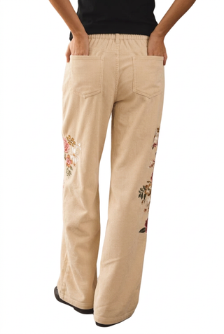 Back view of cream corduroy floral embroidered pants with elastic back waist and pockets