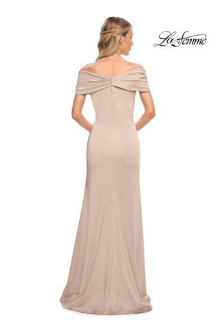 Beige evening gown with a bow detail on a white background, featuring the brand 'La Femme'.