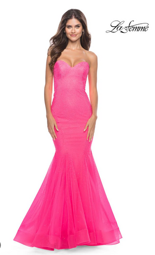 Woman wearing a pink strapless gown on a white background with 'La Femme' branding.
