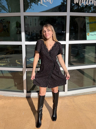 woman in a polka dot black and white wrap dress short