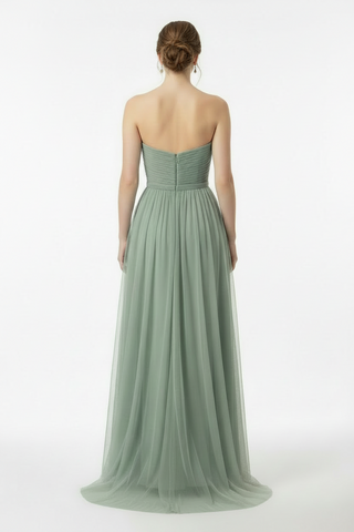 woman is a long sage dress posing for a photo