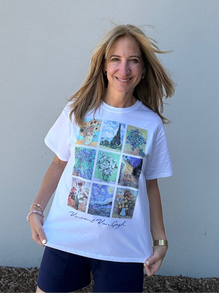 Woman wearing a white t-shirt with colorful graphic design against a plain background