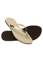 Havaianas You Metallic Sandal in Gold  Say hello to a beloved classic: the Havaianas You! Slim everything... straps and soles with a touch of metallic make this is one of our sleekest styles  Upper: 100% laminado PU Outsole: 100% rubber Thong style Cushioned footbed with textured rice pattern and rubber flip flop sole Made in Brazil
