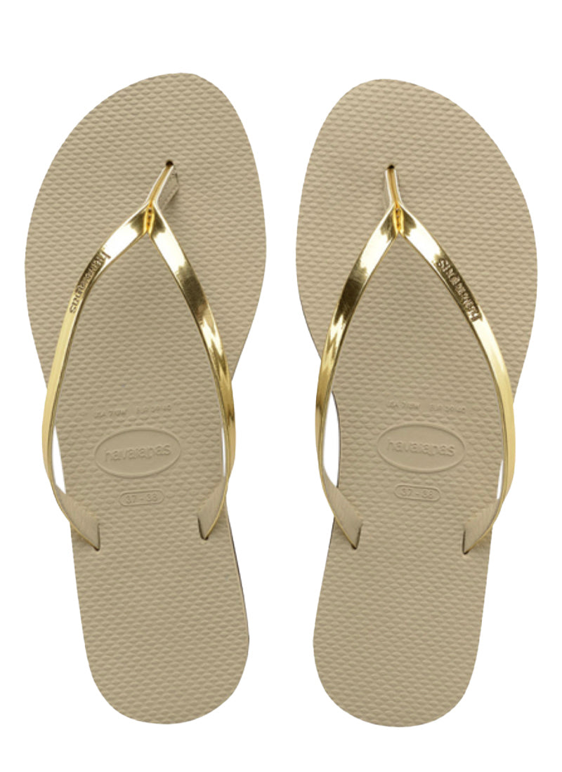 Havaianas You Metallic Sandal in Gold  Say hello to a beloved classic: the Havaianas You! Slim everything... straps and soles with a touch of metallic make this is one of our sleekest styles  Upper: 100% laminado PU Outsole: 100% rubber Thong style Cushioned footbed with textured rice pattern and rubber flip flop sole Made in Brazil