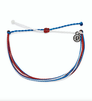 Pura Vida Bright Original Bracelet in Red White Blue  It’s the bracelet that started it all. Each one is handmade, waterproof and totally unique—in fact, the more you wear it, the cooler it looks. Grab yours today to feel the Pura Vida vibes.  Brand: Pura Vida Material: Wax-Coated Size & Fit: Adjustable from 2-5 Inches in Diameter
