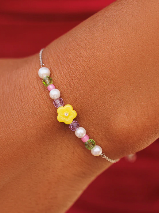 Resin Flower & Mixed Seed Bead Slider Bracelet  Flowers make everything better—just ask our Resin Flower & Mix Seed Bead Slider Bracelet! Set on a delicate silver chain, this dainty design features an enamel flower in the middle, surrounded by colorful beads and itty bitty pearls. on wrist