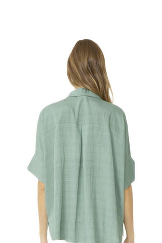 This is the perfect spring time button up collared, 1/2 sleeve top, featuring slits at sleeves. Unlined. Woven. Non-sheer. Lightweight. Back View 80% Rayon 20% Polyester
