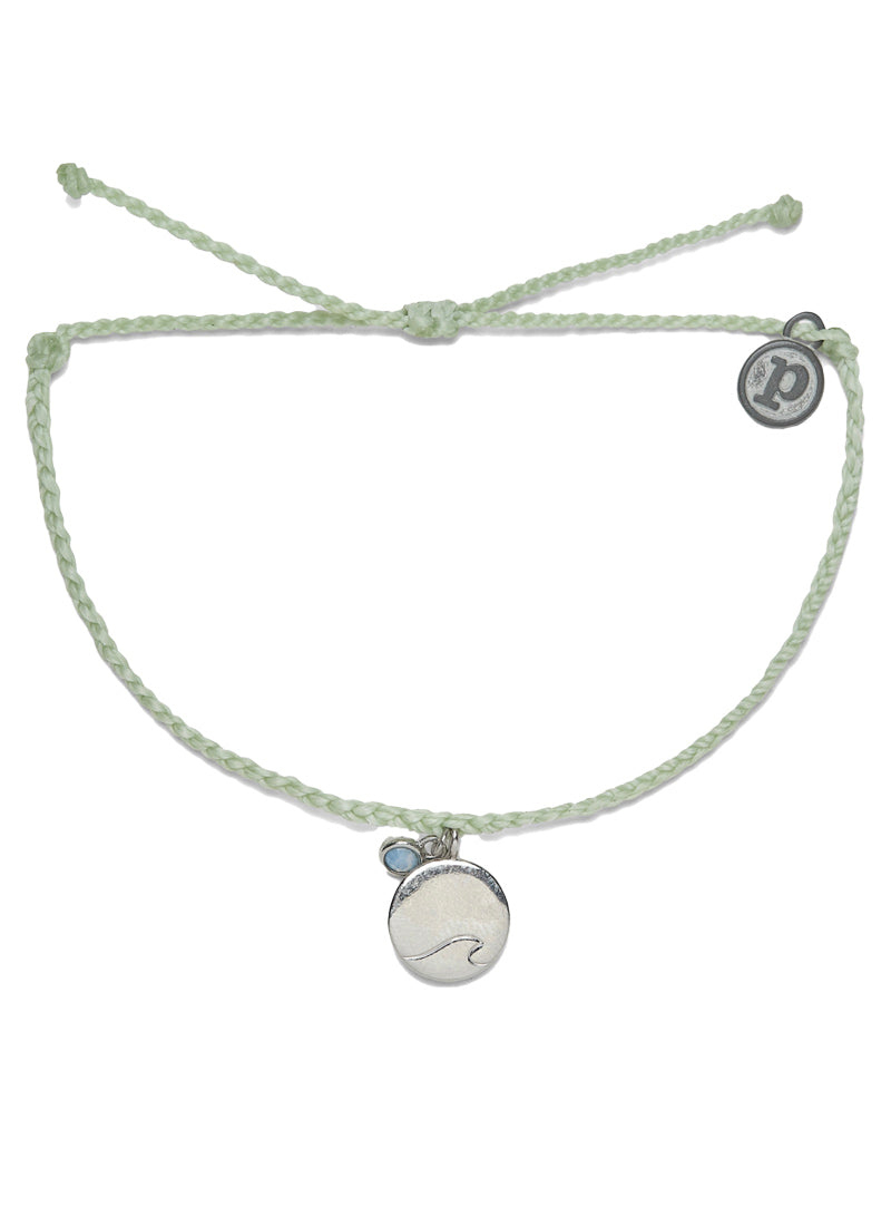 Silver Ride the Wave Charm Bracelet in Mint  This bitty braid design is simple and cute, with a gold enamel charm featuring a wave outline in the center. To say it stole our heart would be a total understatement.  Brand: Pura Vida Material: 100% Waterproof Size & Fit: Adjustable from 2-5 Inches in Diameter 