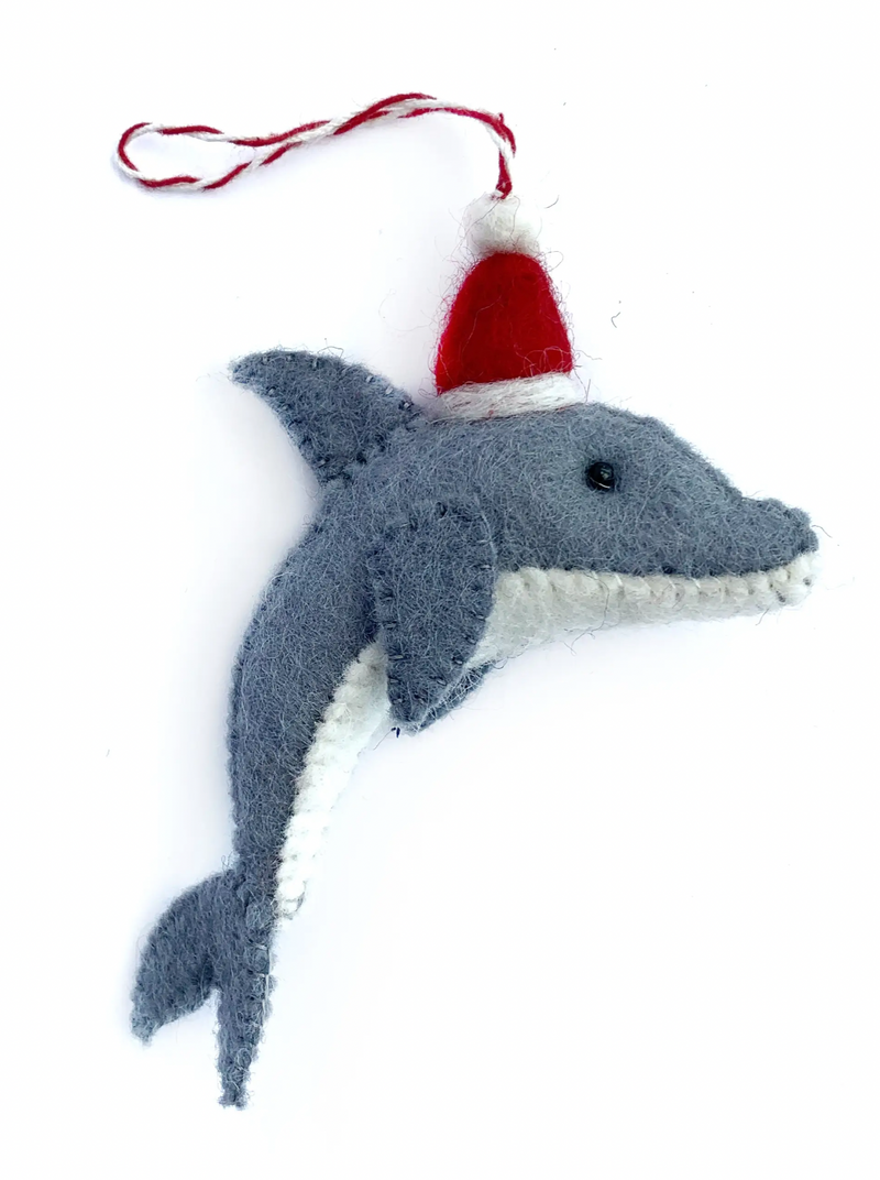 Wool Dolphin Santa Ornament  Adventure under the sea this holiday with our NEW Dolphin Ornament! This friendly fellow is decked out and ready to celebrate in a red Santa hat! Our felt wool ornaments are handmade by artisans in Nepal, Asia using colorful sheep wool. Popular for their charming and durable designs, felted ornaments are perfect for the toughest toddler or curious critter.