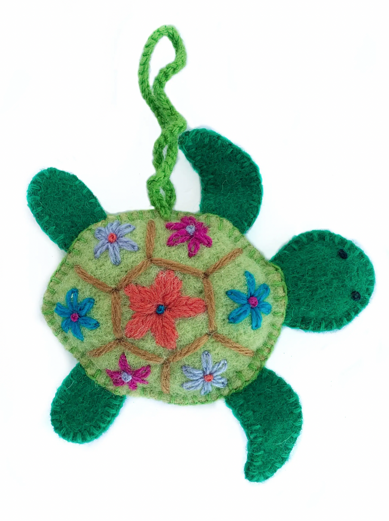 Wool Sea Turtle Ornament  Take a whimsical journey under the sea with our NEW ocean themed Christmas ornaments. This groovy Sea Turtle Ornament is ready to make a splash this holiday season! Handmade by artisans in Peru, South America using traditional craftsmanship, each soft green turtle features floral embroidery on its shell.